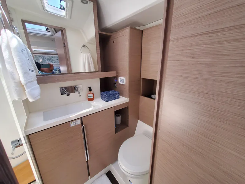 Slide: The Image of Modern bathroom in 2023 Hanse 460 yacht with wood cabinetry and sleek fixtures. - 13