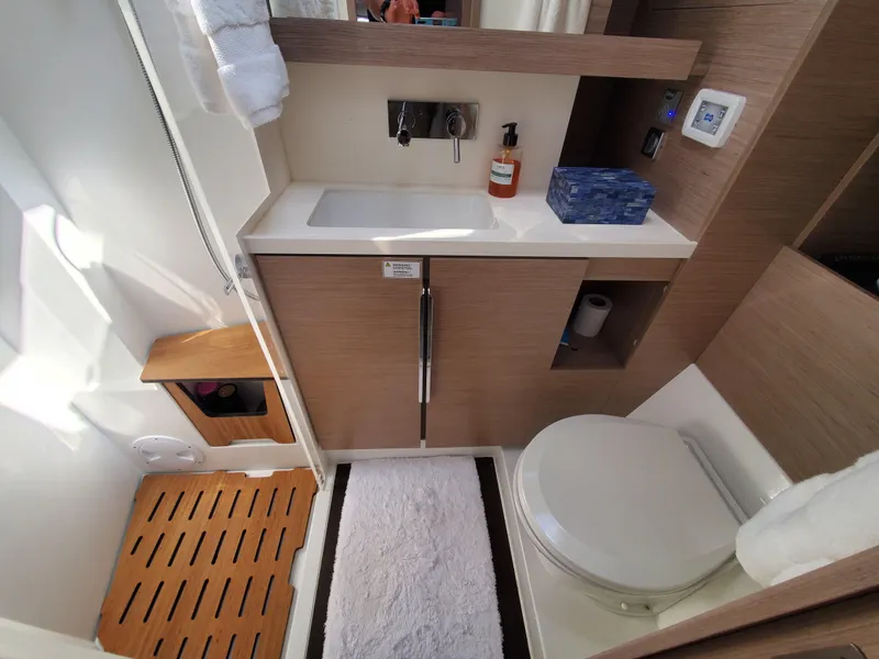 Slide: The Image of Modern bathroom in 2023 Hanse 460 yacht with sink, toilet, and wooden accents. - 14