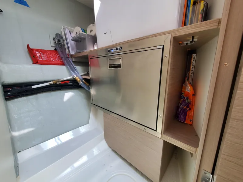 Slide: The Image of 2023 Hanse 460 yacht interior with stainless steel storage and organized compartments. - 35