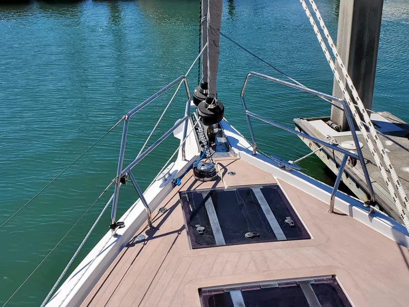 Slide: The Image of Bow of 2023 Hanse 460 sailboat docked in marina, featuring sleek deck design. - 48