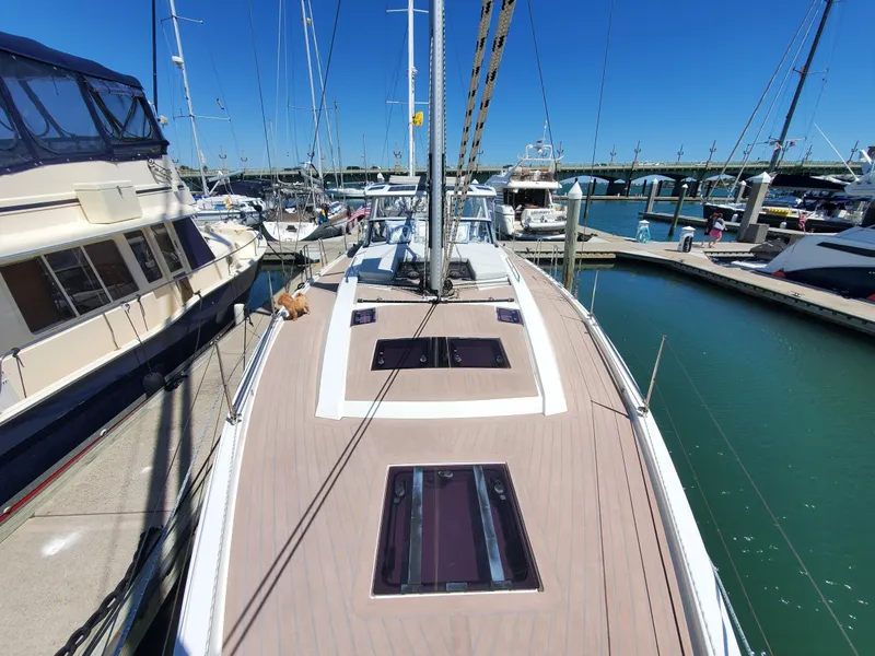 Slide: The Image of 2023 Hanse 460 yacht docked at marina, showcasing sleek deck design and modern features. - 49