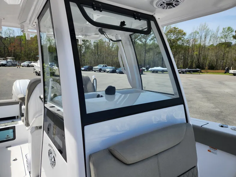 Slide: The Image of 2025 Sportsman Heritage 261 Center Console boat interior with seating and console view. - 12