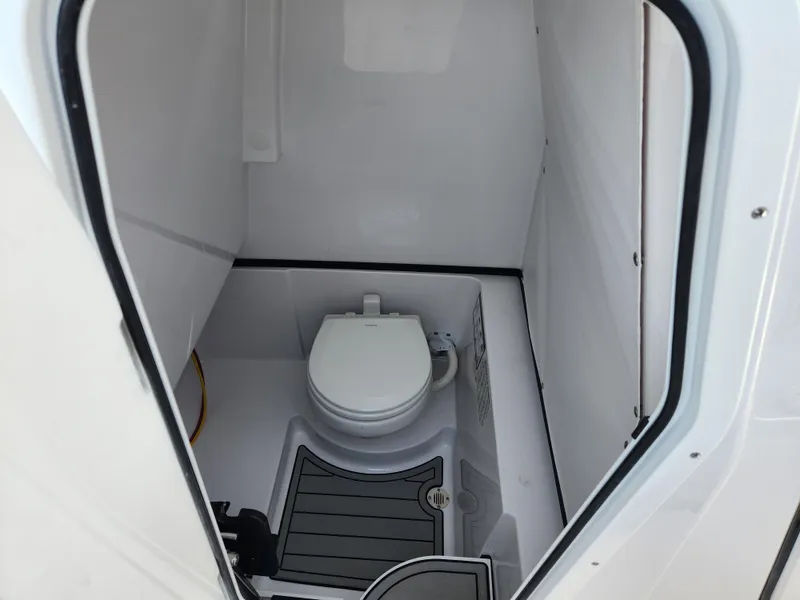 Slide: The Image of 2025 Sportsman Heritage 261 Center Console boat interior with compact marine toilet. - 14