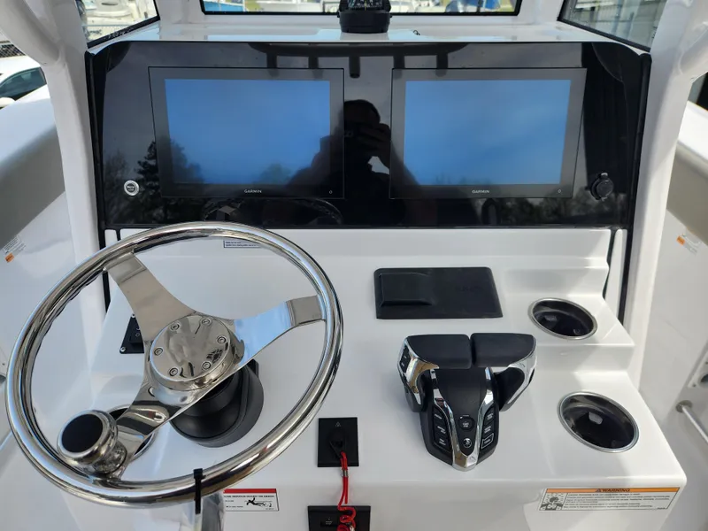 Slide: The Image of 2025 Sportsman Heritage 261 Center Console dashboard with dual screens and steering wheel. - 15