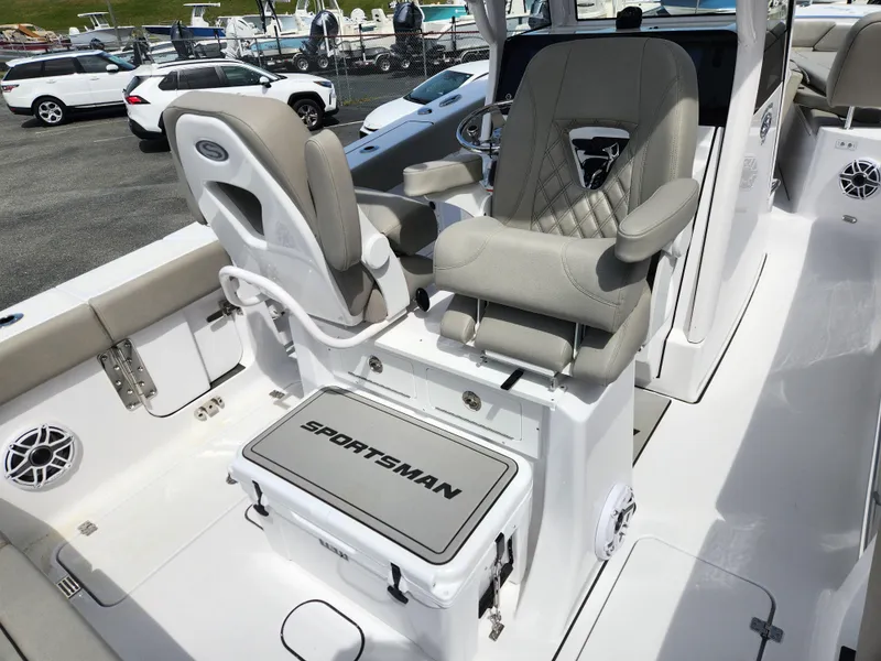 Slide: The Image of 2025 Sportsman Heritage 261 Center Console boat interior with cushioned seating and storage. - 18