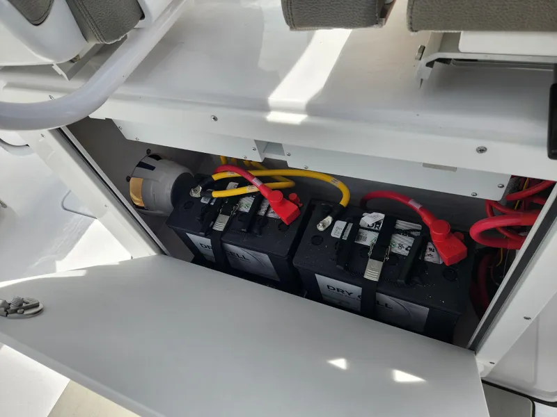 Slide: The Image of 2025 Sportsman Heritage 261 Center Console battery compartment with wiring and components. - 19