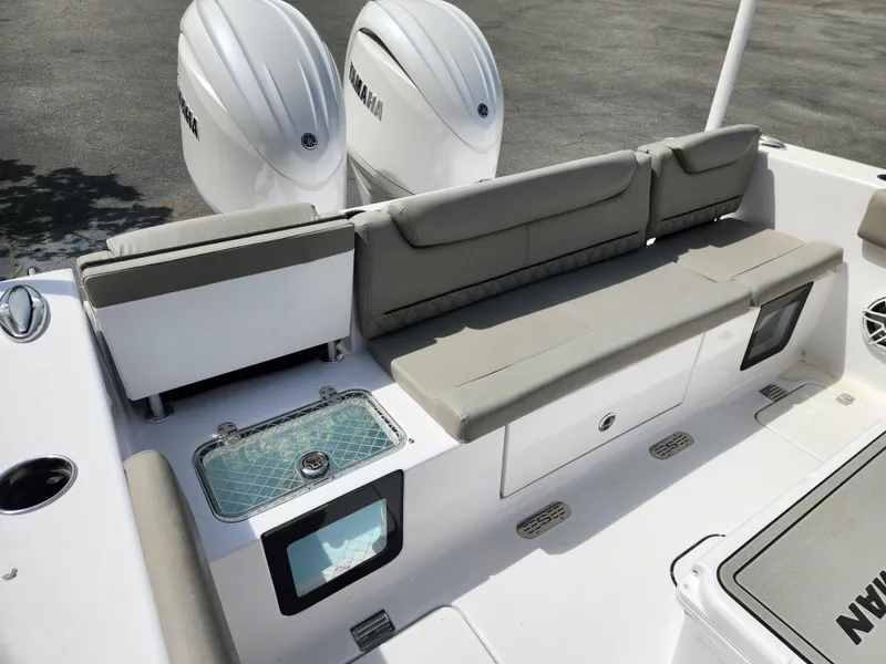 Slide: The Image of 2025 Sportsman Heritage 261 Center Console boat interior with seating and dual engines. - 21
