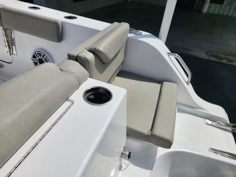 Slide: The Image of 2025 Sportsman Heritage 261 Center Console boat seating with cup holder and speaker. - 22