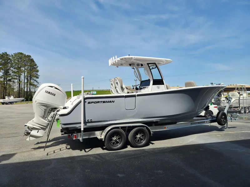 Slide: The Image of 2025 Sportsman Heritage 261 Center Console boat on trailer, parked outdoors. - 5