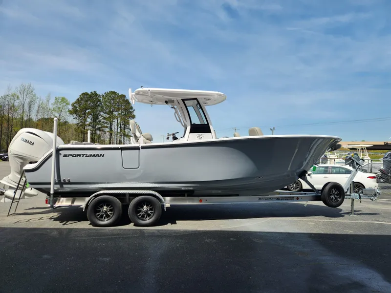 Slide: The Image of 2025 Sportsman Heritage 261 Center Console boat on trailer, parked outdoors. - 6