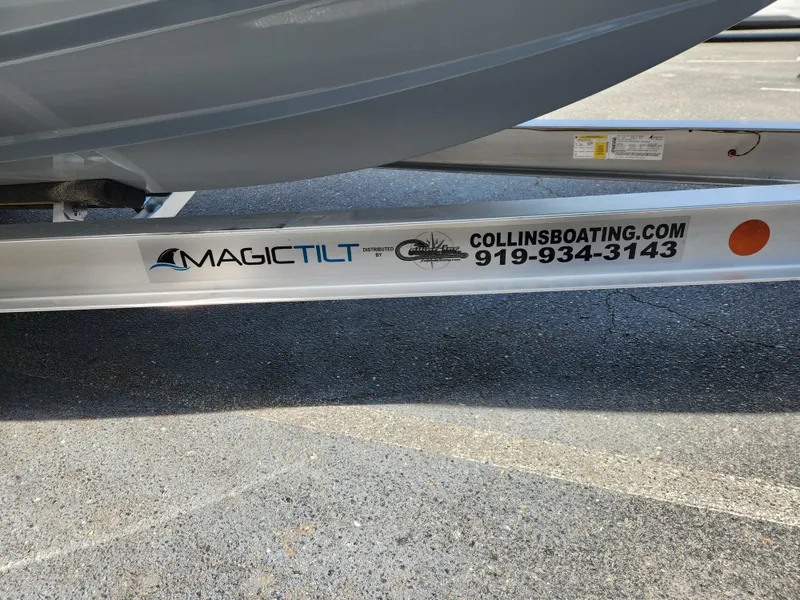 Slide: The Image of Trailer for 2025 Sportsman Heritage 261 Center Console with Magic Tilt branding. - 8