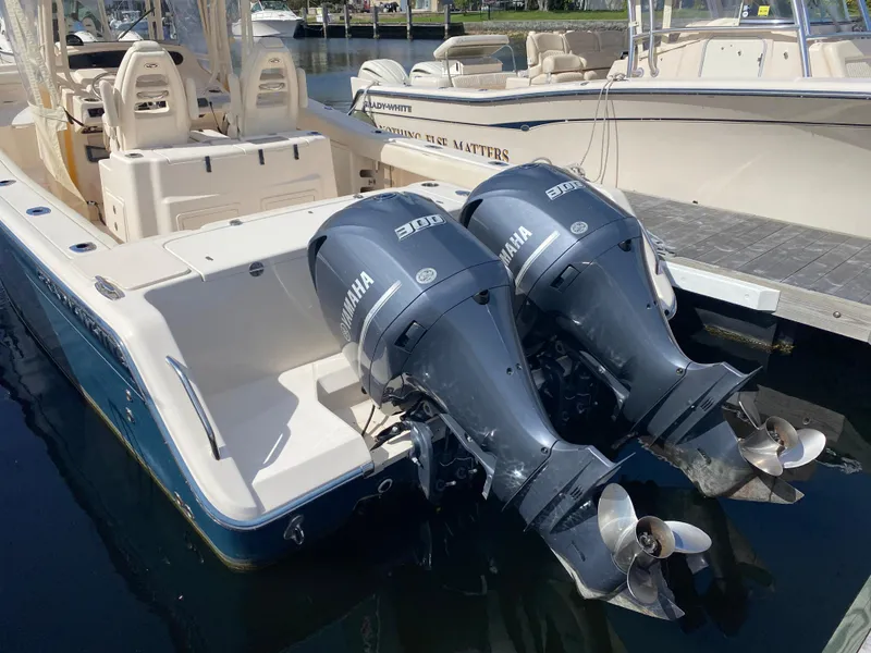 Slide: The Image of 2016 Grady-White Canyon boat with twin Yamaha outboard engines docked at marina. - 3
