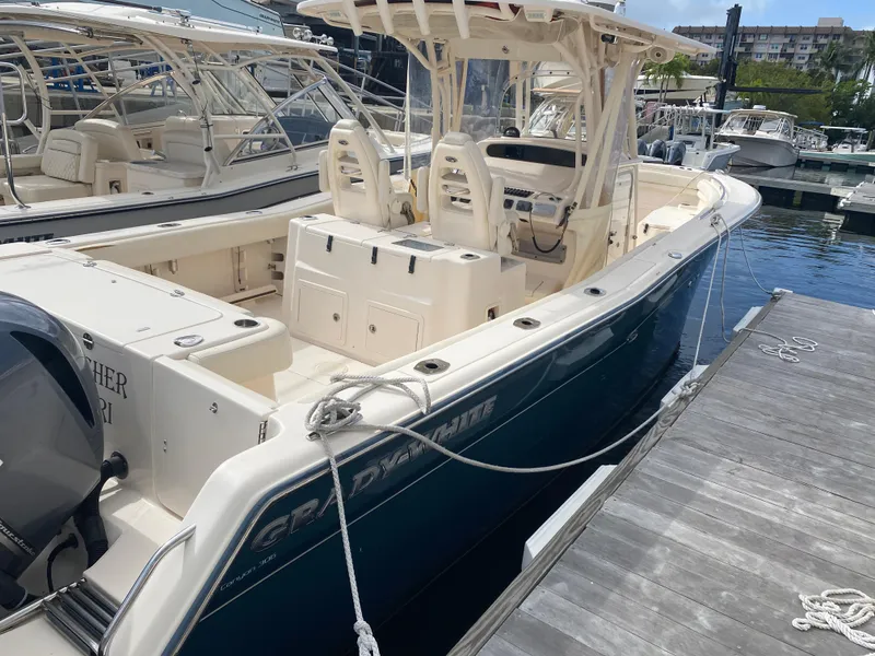 Slide: The Image of 2016 Grady-White Canyon boat docked at marina, featuring sleek design and spacious deck. - 4