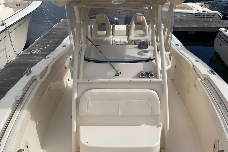 Slide: The Image of 2016 Grady-White Canyon boat docked, showcasing spacious deck and seating area. - 5