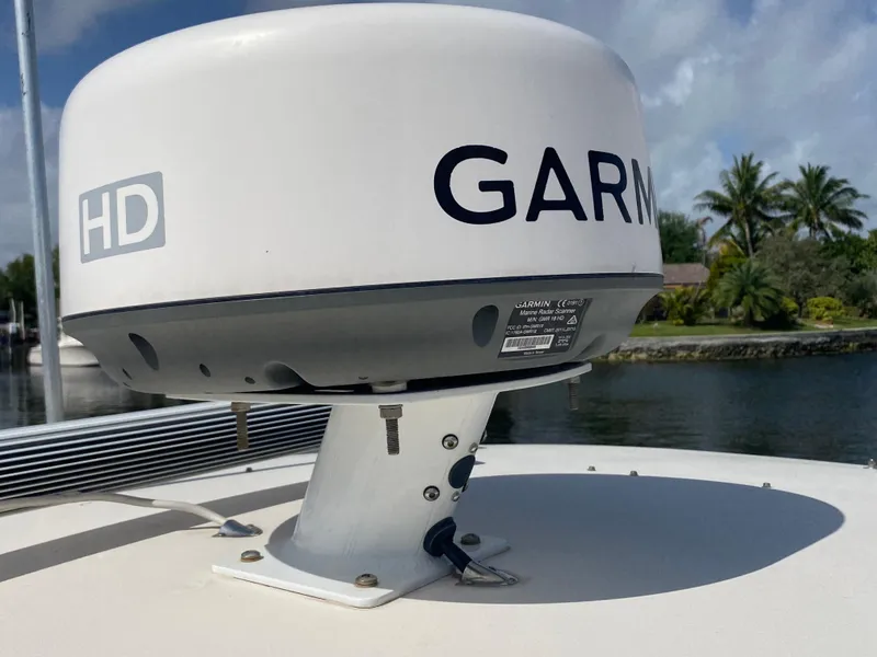 Slide: The Image of Garmin HD radar on 2016 Grady-White Canyon boat, docked near tropical scenery. - 6