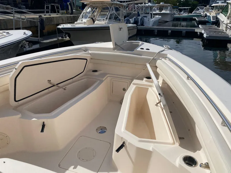 Slide: The Image of 2016 Grady-White Canyon boat interior with open storage compartments at marina. - 7