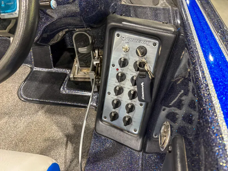 Slide: The Image of Control panel of a 2020 Phoenix 921 ELITE boat with switches and key. - 14