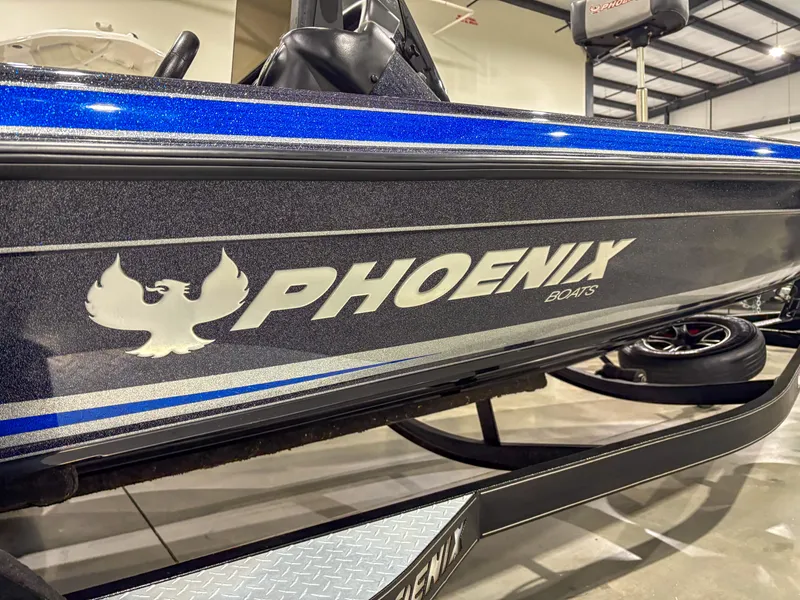 Slide: The Image of 2020 Phoenix 921 ELITE boat with blue and silver detailing in a showroom. - 3