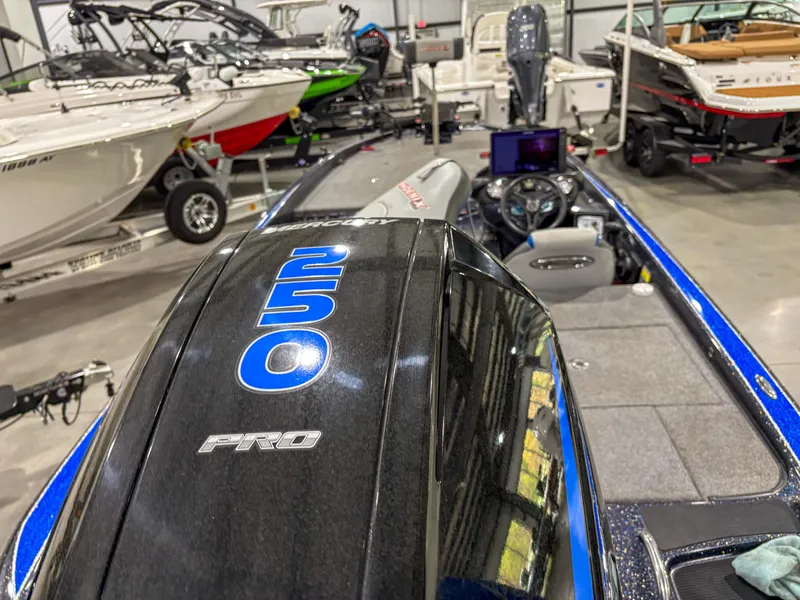 Slide: The Image of 2020 Phoenix 921 ELITE boat with powerful engine in showroom, surrounded by other boats. - 4