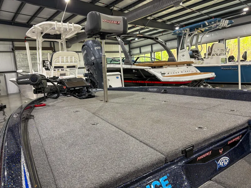 Slide: The Image of 2020 Phoenix 921 ELITE boat in showroom, featuring spacious deck and advanced equipment. - 9