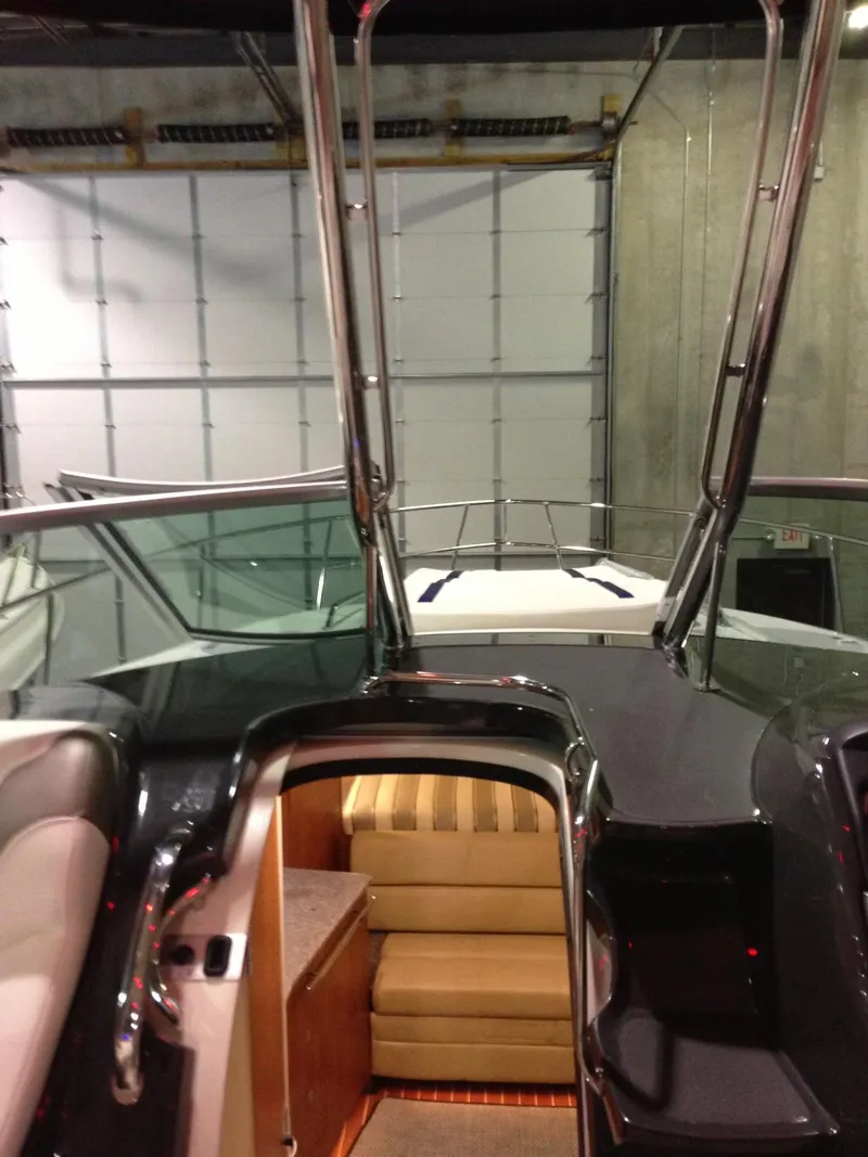 Slide: The Image of 2013 Monterey 340 SY boat interior with stairs and seating, docked in a garage. - 10