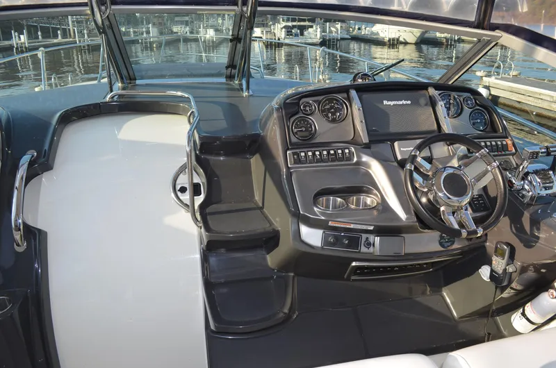 Slide: The Image of 2013 Monterey 340 SY boat cockpit with modern controls and steering wheel, docked at marina. - 11