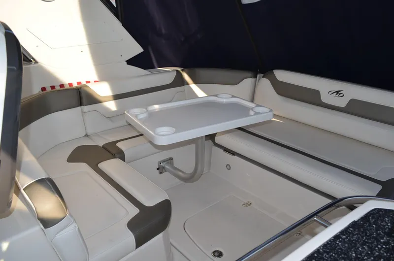 Slide: The Image of Interior seating area of a 2013 Monterey 340 SY boat with table and cushions. - 12