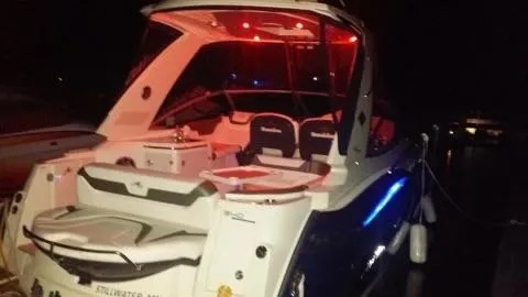 Slide: The Image of 2013 Monterey 340 SY boat with illuminated interior and exterior lights at night. - 15