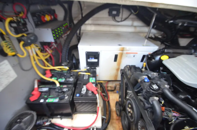 Slide: The Image of Engine compartment of a 2013 Monterey 340 SY boat, featuring batteries and wiring. - 21