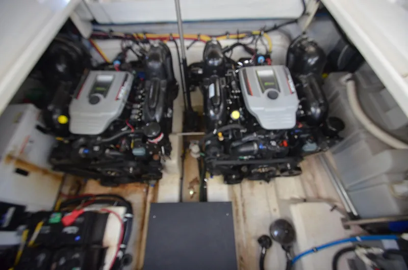 Slide: The Image of Engine compartment of a 2013 Monterey 340 SY boat, featuring dual engines. - 23