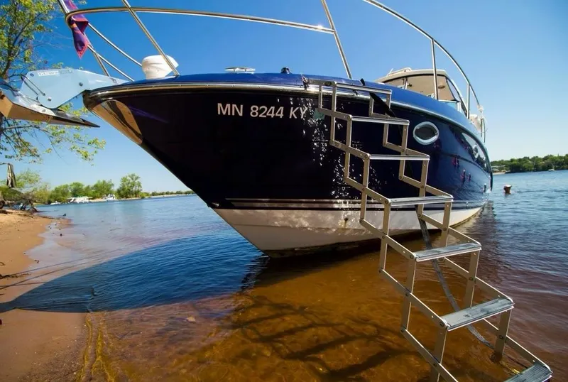 Slide: The Image of 2013 Monterey 340 SY boat docked on a sunny lake with metal ladder. - 4