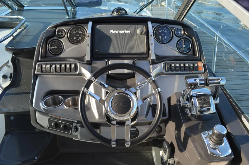 Slide: The Image of Cockpit of 2013 Monterey 340 SY boat with steering wheel and navigation controls. - 7