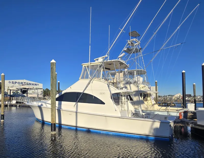 Slide: The Image of 2001 Ocean Yachts 43 Super Sport docked at marina under clear blue sky. - 1