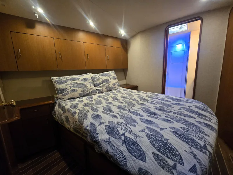 Slide: The Image of Cozy bedroom in 2001 Ocean Yachts 43 Super Sport with fish-patterned bedding. - 19