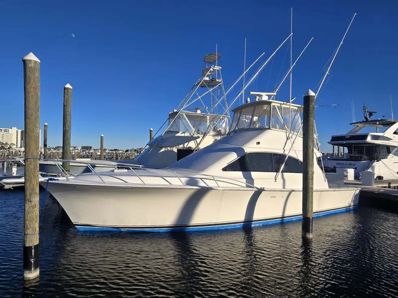 Slide: The Image of 2001 Ocean Yachts 43 Super Sport docked at marina under clear blue sky. - 2