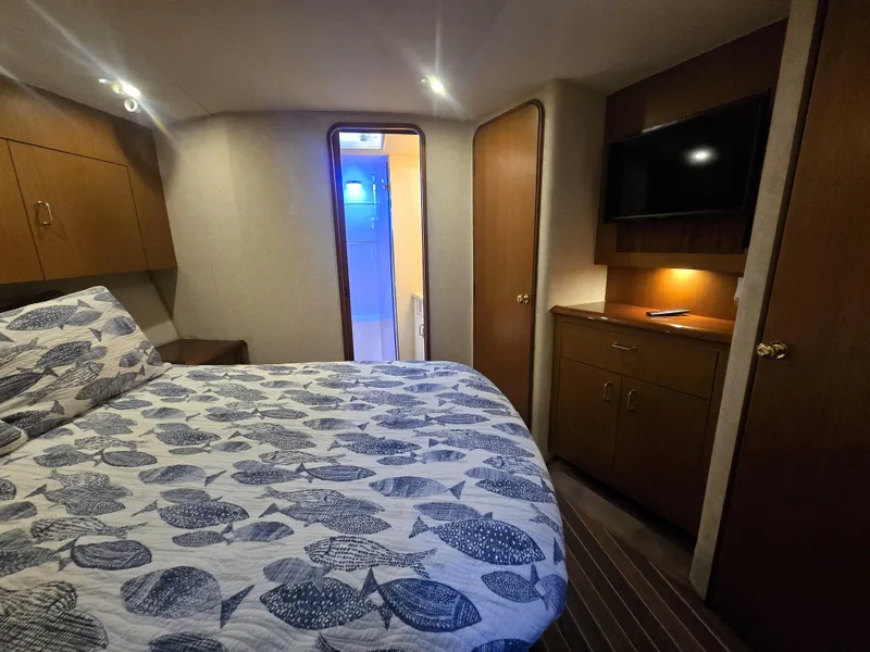 Slide: The Image of Luxurious cabin interior of 2001 Ocean Yachts 43 Super Sport with cozy bed and TV. - 20