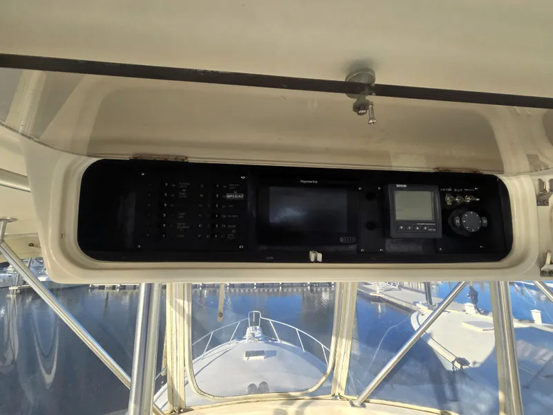 Slide: The Image of 2001 Ocean Yachts 43 Super Sport helm with navigation equipment and marina view. - 8