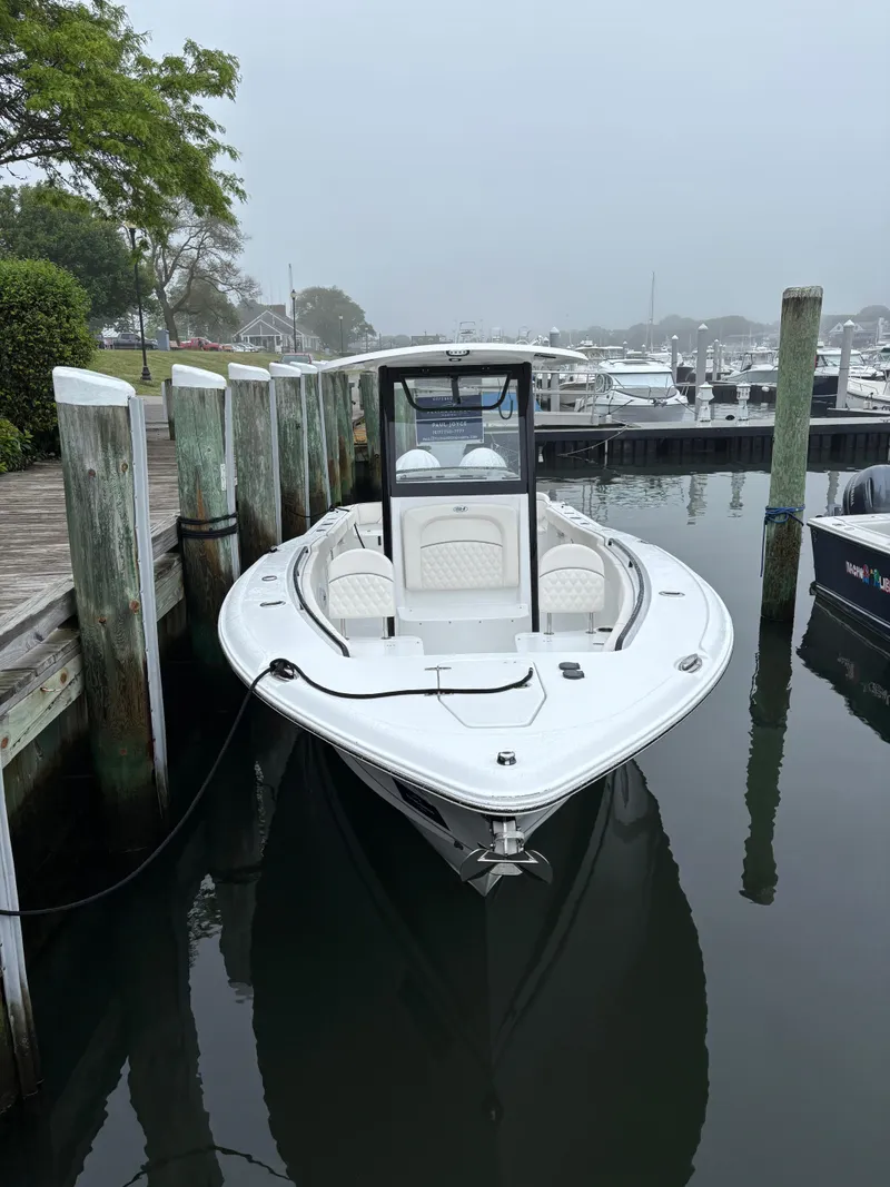 Slide: The Image of 2025 Sea Hunt Ultra 275 SE boat docked in a marina, front view. - 3