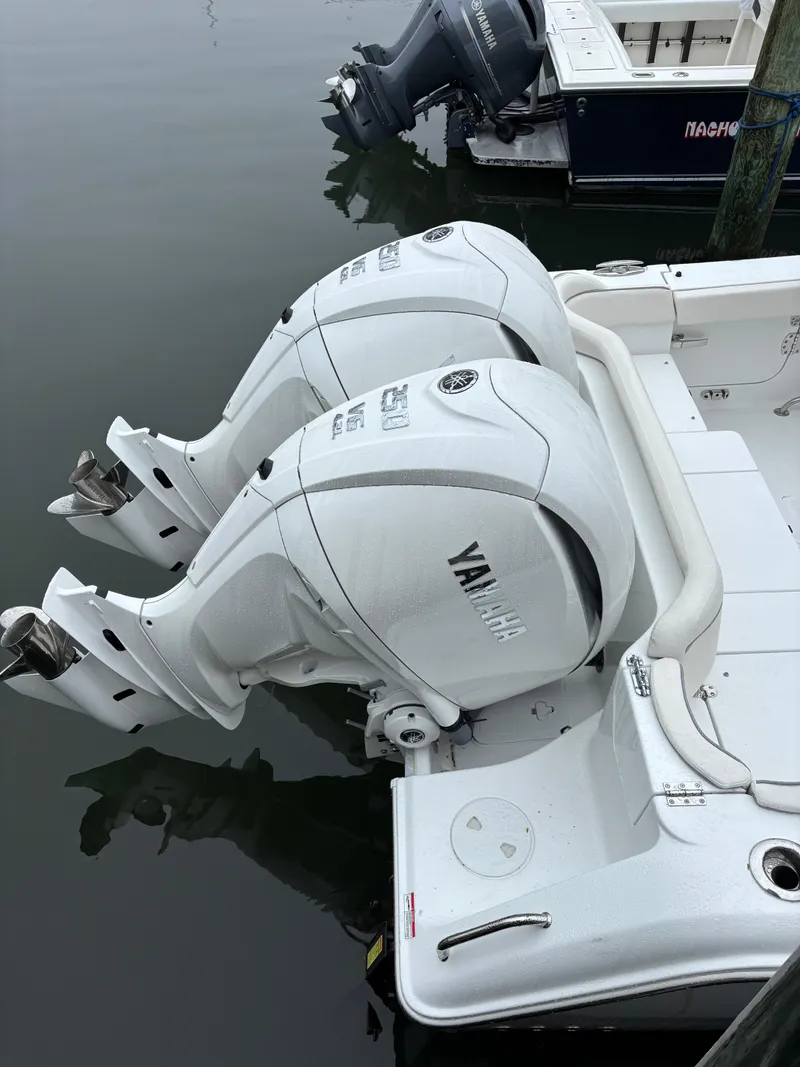 Slide: The Image of 2025 Sea Hunt Ultra 275 SE with twin Yamaha outboard engines docked. - 6