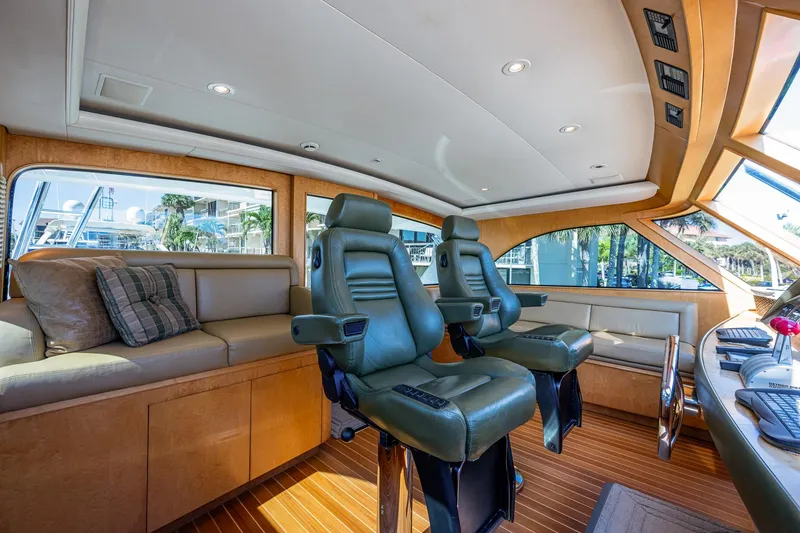 Slide: The Image of 2001 American Custom Enclosed Flybridge interior with leather seats and wood accents. - 11