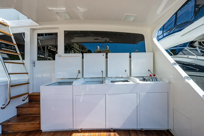 Slide: The Image of 2001 American Custom Enclosed Flybridge yacht with sleek white cabinetry and wooden flooring. - 12