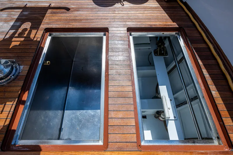 Slide: The Image of Open hatches on teak deck of 2001 American Custom Enclosed Flybridge yacht. - 17