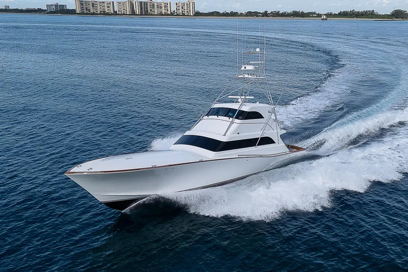 Slide: The Image of 2001 American Custom Enclosed Flybridge yacht cruising on open water. - 2