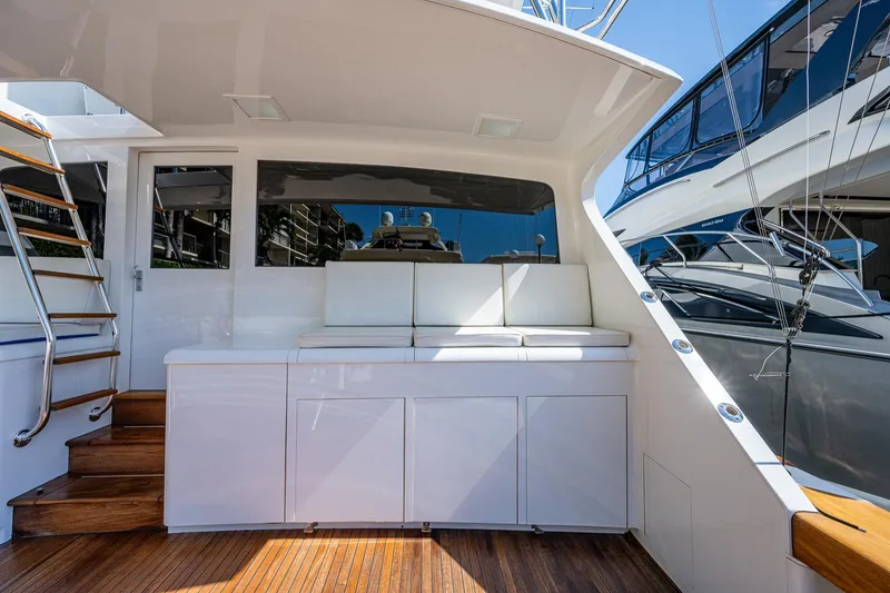 Slide: The Image of 2001 American Custom Enclosed Flybridge yacht interior with white seating and wooden flooring. - 20