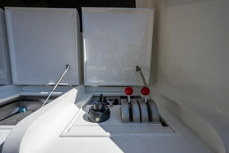 Slide: The Image of Control panel of a 2001 American Custom Enclosed Flybridge yacht with levers and switches. - 21