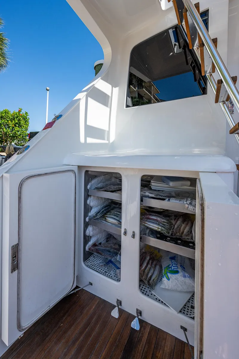 Slide: The Image of 2001 American Custom Enclosed Flybridge with open storage compartments on deck. - 22