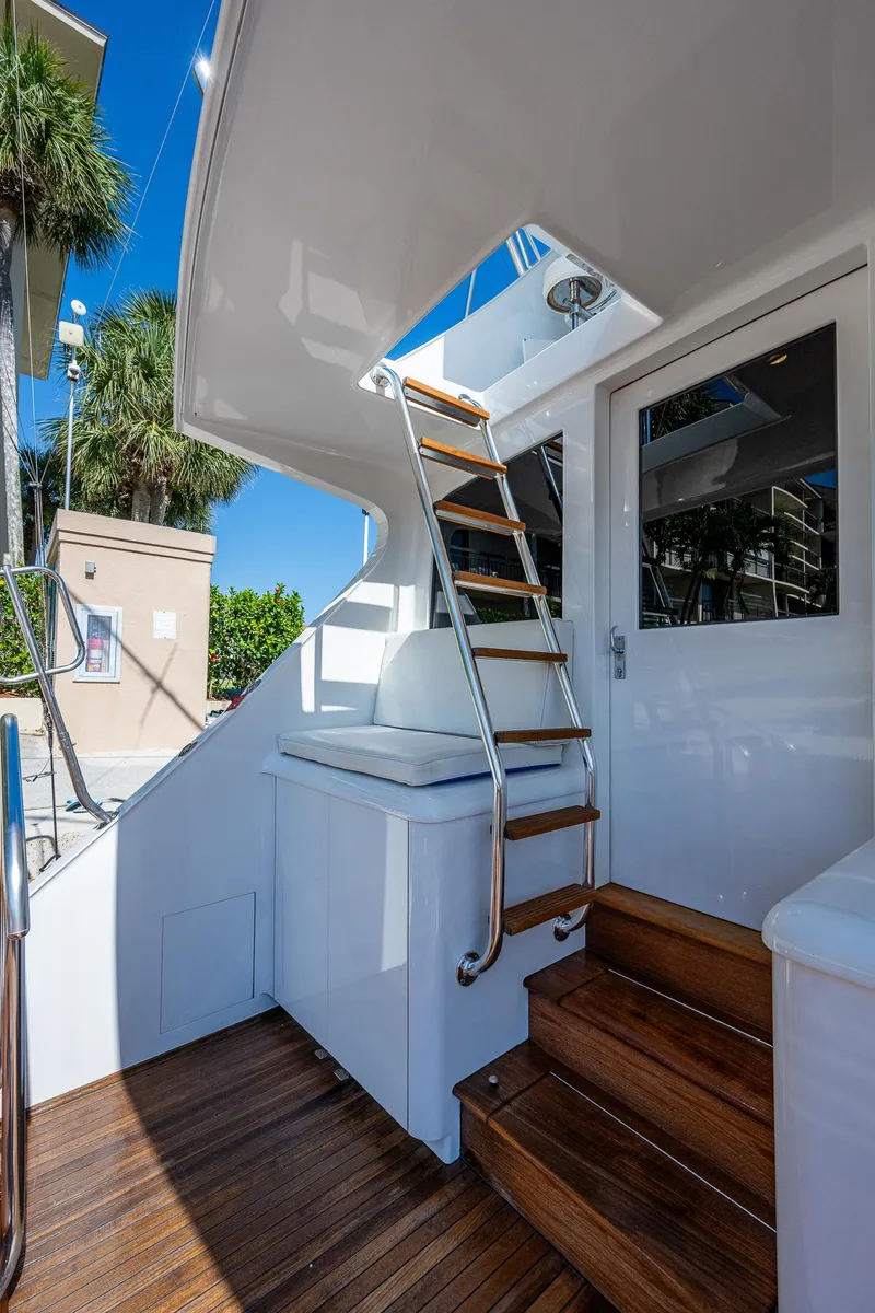 Slide: The Image of 2001 American Custom Enclosed Flybridge yacht with wooden steps and sleek white exterior. - 24