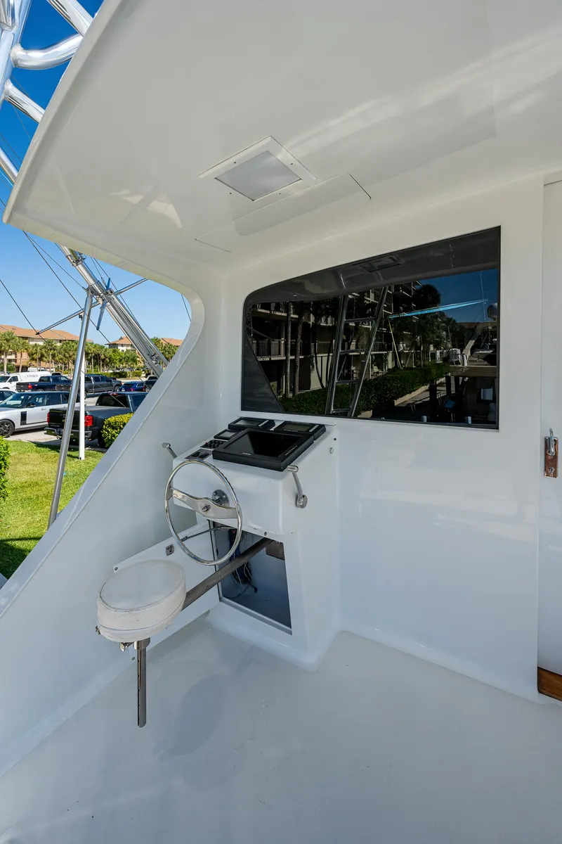 Slide: The Image of 2001 American Custom Enclosed Flybridge yacht helm station with modern controls. - 27