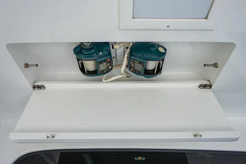 Slide: The Image of 2001 American Custom Enclosed Flybridge fishing reel storage compartment. - 29