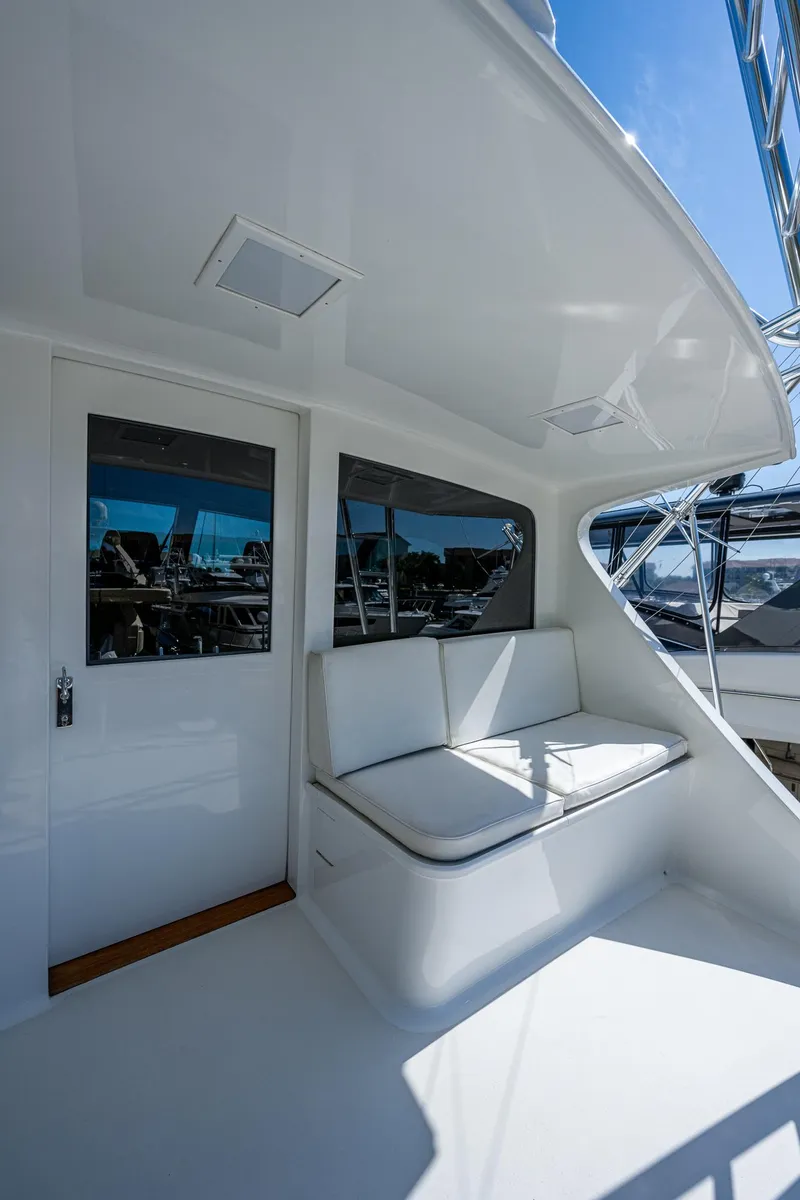 Slide: The Image of 2001 American Custom Enclosed Flybridge with white seating and sleek design. - 30